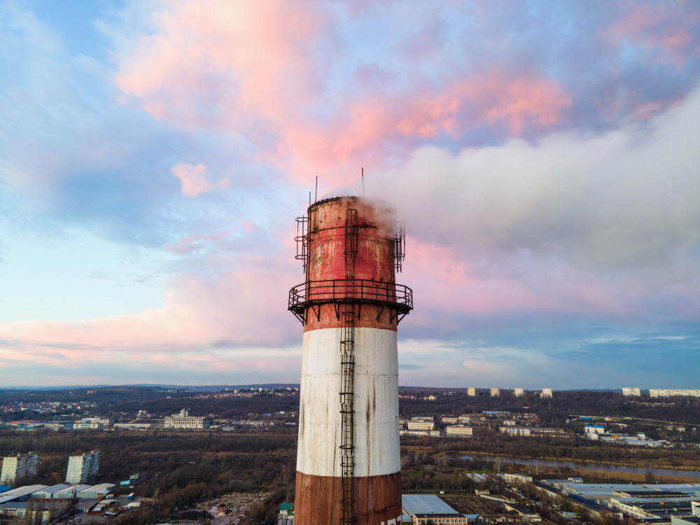 /upl/aerial-drone-view-thermal-station-sunset-with-smoke-coming-out-tube.jpg