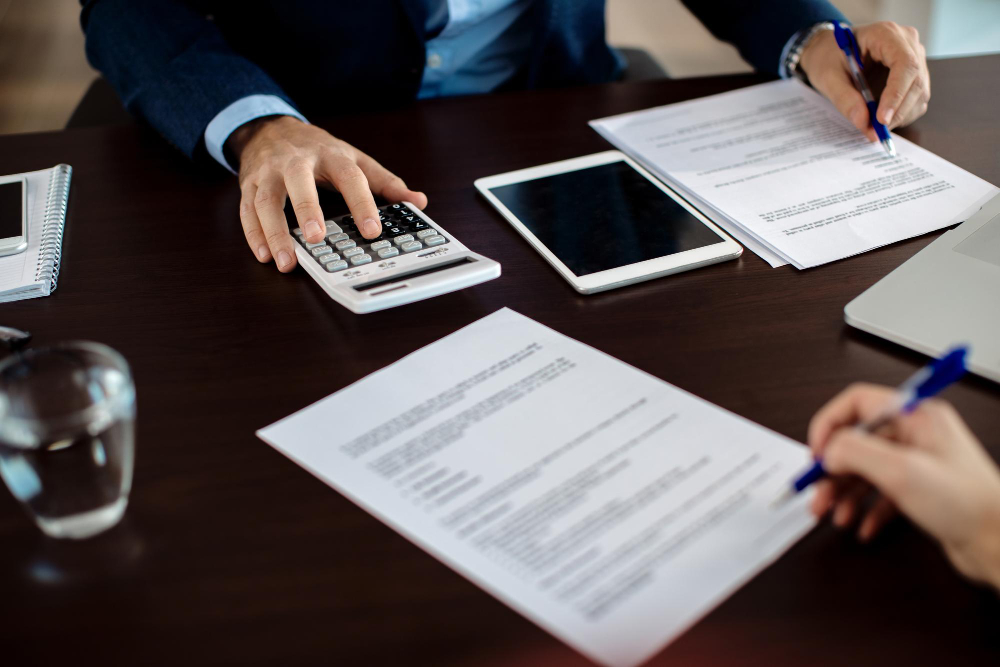 /upl/closeup-financial-consultant-going-through-paperwork-meeting-with-client.jpg