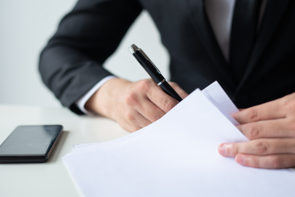 /upl/closeup-of-business-man-signing-document-at-office-desk.jpg