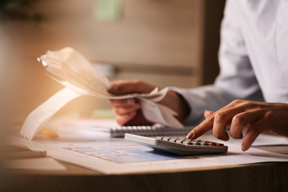 /upl/closeup-of-economist-using-calculator-while-going-through-bills-and-taxes-in-the-office_1.jpg