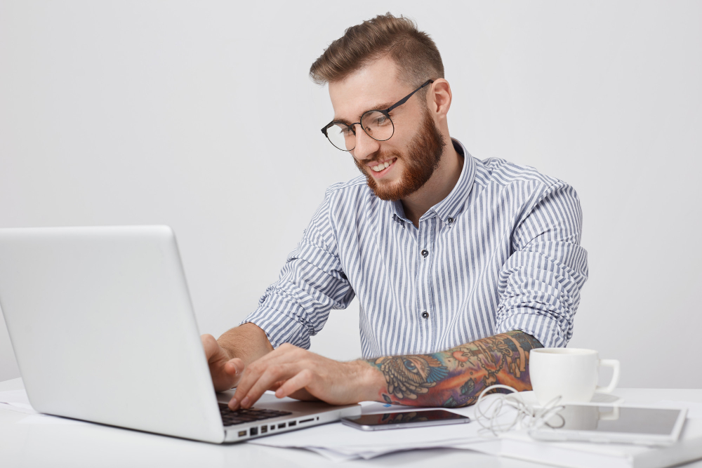 /upl/glad-fashionable-man-with-smile-types-on-generic-laptop-checks-e-mail-or-messages-online_1.jpg