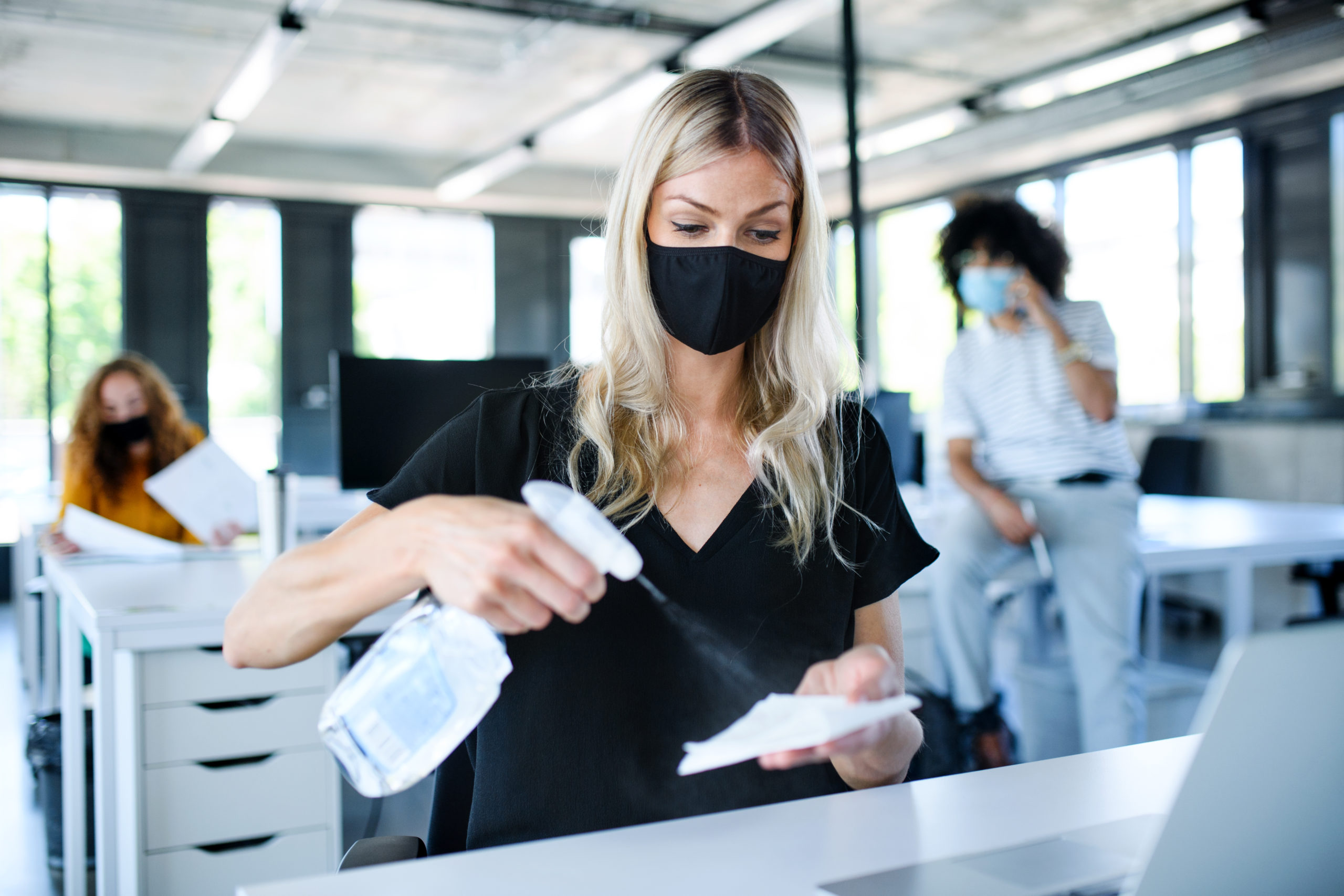 /upl/young-woman-with-face-mask-back-at-work-in-office-2CMYZKV-scaled.jpg